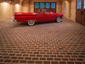 A car in a garage with a brick floor